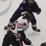 Homers Brenna McCarron blocks the path of Juneaus Dalton Hoy Friday in a Div. II state semifinal at the Curtis Menard Sports Complex in Wasilla. (Photo by Joey Klecka/Peninsula Clarion)