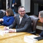 In this Jan. 8, 2019, file photo, Alaska Department of Administration Commissioner nominee Jonathan Quick, second from right, speaks with Revenue Commissioner Bruce Tangeman, right, before the start of a cabinet meeting at the state Capitol. Quick was accused of lying about his business background that he had an ownership interest in Anthem Coffee and Tea and Elements Frozen Yogurt. (AP Photo/Becky Bohrer, File)