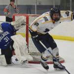 Homers Isaiah Nevak celebrates a late game-tying goal on Palmer goalie Tiernan ORourke Saturday night at the Curtis Menard Sports Complex in Wasilla. (Photo by Joey Klecka/Peninsula Clarion)
