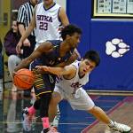Homer sophomore Eyoab Knapp protects the ball from Sitka senior CJ Taccad (11) as Wolves senior John Arce looks on (23). (Photo by Klas Stolpe)