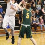 Homers Stanley Swoboda takes a shot at Sewards basket Friday, Feb. 8, 2019 during the Winter Carnival Basketball Tournament in Homer, Alaska. (Photo by Megan Pacer/Homer News)