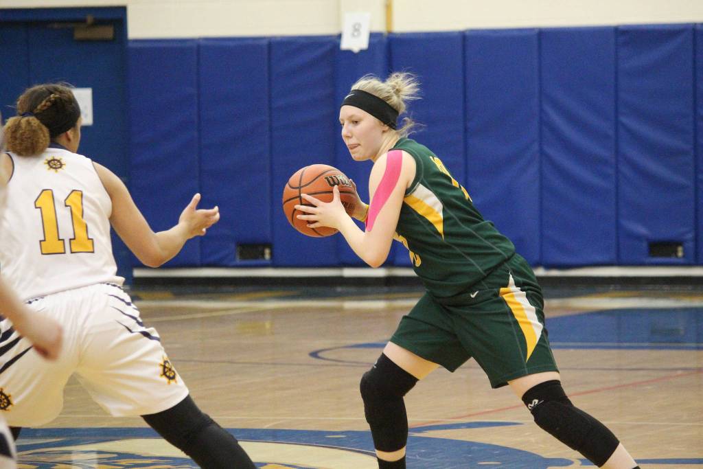 Sewards Katelyn Lemme looks for a way around Homers Alia Bales on Friday, Feb. 8, 2019 during the Winter Carnival Basketball Tournament in Homer, Alaska. (Photo by Megan Pacer/Homer News)