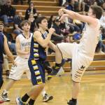 Homers Stanley Swoboda sends the ball over Galenas Joe Riddle on Thursday, Feb. 7, 2019 during the Winter Carnival Basketball Tournament in Homer, Alaska. (Photo by Megan Pacer/Homer News)