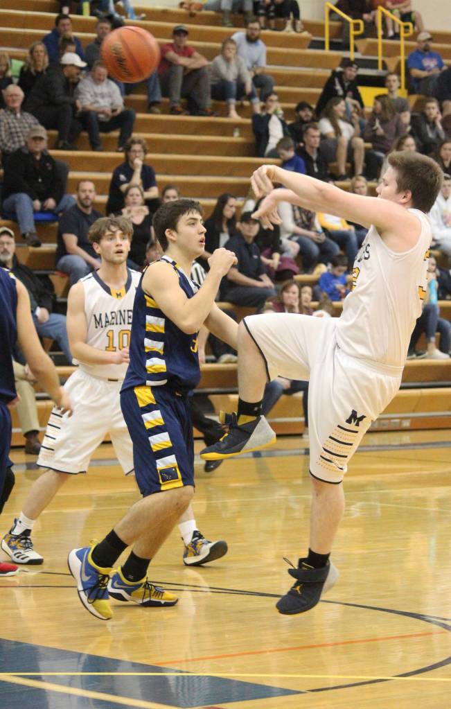 Homers Stanley Swoboda sends the ball over Galenas Joe Riddle on Thursday, Feb. 7, 2019 during the Winter Carnival Basketball Tournament in Homer, Alaska. (Photo by Megan Pacer/Homer News)