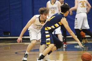 Galenas Kevin Bergman looks for a way around Homers Seth Adkins on Thursday, Feb. 7, 2019 during the Winter Carnival Basketball Tournament in Homer, Alaska. (Photo by Megan Pacer/Homer News)