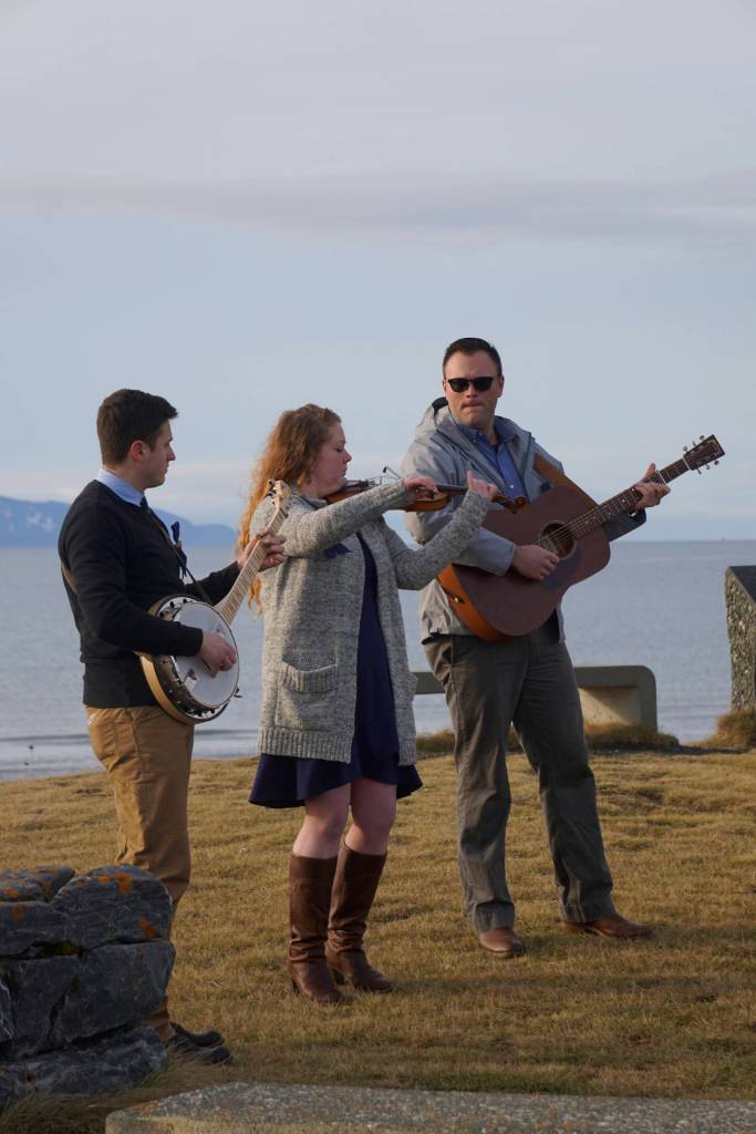 From left to right, Josh Kennedy, Kate Klann and Geddy Miller perform I Bid You Goodbye at a memorial service for Chief Warrant Officer Michael Kozloski on Friday morning, Feb. 8, 2019, at the Seafarers Memorial on the Homer Spit, Homer, Alaska. Kennedy served on the U.S. Coast Cutter Hickory with Kozloski and Miller is captain of the U.S. Coast Guard Cutter Naushon. (Photo by Michael Armstrong/Homer News)