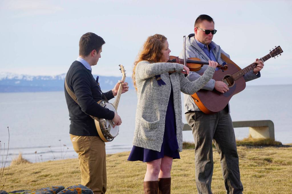 From left to right, Josh Kennedy, Kate Klann and Geddy Miller perform I Bid You Goodbye at a memorial service for Chief Warrant Officer Michael Kozloski on Friday morning, Feb. 8, 2019, at the Seafarers Memorial on the Homer Spit, Homer, Alaska. Kennedy served on the U.S. Coast Cutter Hickory with Kozloski and Miller is captain of the U.S. Coast Guard Cutter Naushon. (Photo by Michael Armstrong/Homer News)