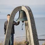 Seaman James Cloutier of the U.S. Coast Guard Cutter Hickory rings the end-of-watch bell for Chief Warrant Officer Michael Kozloski at a memorial service for him on Friday morning, Feb. 8, 2019, at the Seafarers Memorial on the Homer Spit, Homer, Alaska. (Photo by Michael Armstrong/Homer News)