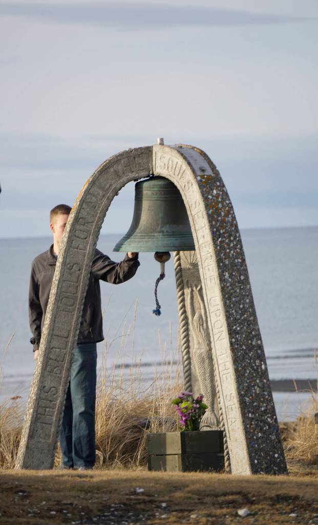 Seaman James Cloutier of the U.S. Coast Guard Cutter Hickory rings the end-of-watch bell for Chief Warrant Officer Michael Kozloski at a memorial service for him on Friday morning, Feb. 8, 2019, at the Seafarers Memorial on the Homer Spit, Homer, Alaska. (Photo by Michael Armstrong/Homer News)
