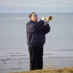 Cristy Hill plays Taps at a memorial service for Chief Warrant Officer Michael Kozloski on Friday morning, Feb. 8, 2019, at the Seafarers Memorial on the Homer Spit, Homer, Alaska. (Photo by Michael Armstrong/Homer News)
