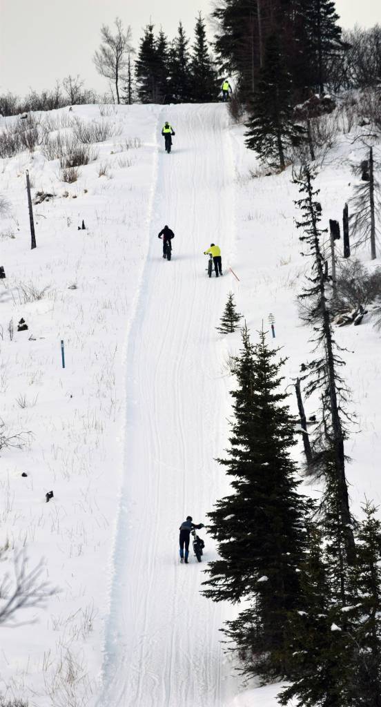 A hill challenges racers during Fat Freddies Bike Race and Ramble on Saturday, Feb. 9, 2019, in the Caribou Hills near Freddies Roadhouse. (Photo by Jeff Helminiak/Peninsula Clarion)