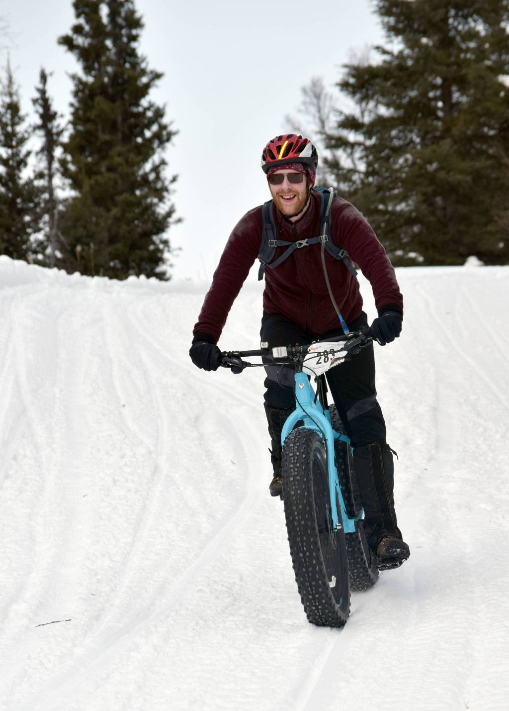 Ryan Peterson sails down a hill during Fat Freddies Bike Race and Ramble on Saturday, Feb. 9, 2019, in the Caribou Hills near Freddies Roadhouse. (Photo by Jeff Helminiak/Peninsula Clarion)