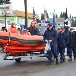 Members of the U.S. Coast Guard march down Pioneer Avenue as the Grand Marshals of this years Winter Carnival Parade on Saturday, Feb. 9, 2019 in Homer, Alaska. (Photo by Megan Pacer/Homer News)