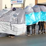 Members of the Kachemak Bay Campus Student Association march down Pioneer Avenue in a whale costume Saturday, Feb. 9, 2019 during the Winter Carnival Parade in Homer, Alaska. (Photo by Megan Pacer/Homer News)