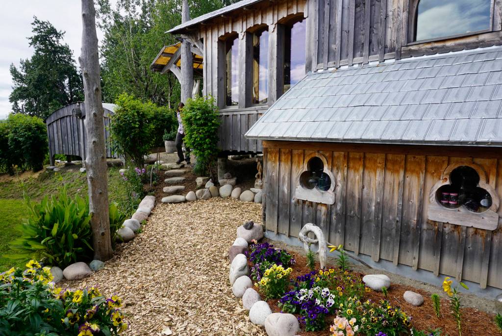 Drifwood and rock is used to line the gardens at the Jeff and Ranja Dean farm. It was one of five gardens featured in the 2018 Homer Garden Tour. (Photo by Michael Armstrong/Homer News)