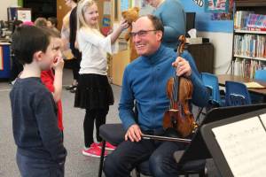 Daniel Perry answers questions from students after a concert Friday, Feb. 15, 2019 at Paul Banks Elementary School in Homer, Alaska. (Photo by Megan Pacer/Homer News)