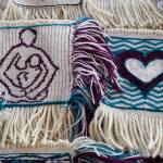 Woven squares by Chloe French, left, and Kathryn Rousso are part of the Giving Strength Robe project on Friday, Feb. 15, 2019. Juneau weaver Lily Hope is organizing dozens of Chilkat and Ravenstail weavers from all over North America to weave 5-inch-by-5-inch squares that will be combined to make one traditional indigenous robe. Once completed, the robe will be given to Aiding Women in Abuse and Rape Emergencies (AWARE). (Michael Penn | Juneau Empire)