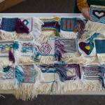 Weaver Lily Hope lays out woven squares for a new project called the Giving Strength Robe on Friday, Feb. 15, 2019. Hope is organizing dozens of Chilkat and Ravenstail weavers from all over North America to weave 5-inch-by-5-inch squares that will be combined to make one traditional indigenous robe. Once completed, the robe will be given to Aiding Women in Abuse and Rape Emergencies (AWARE). (Michael Penn | Juneau Empire)