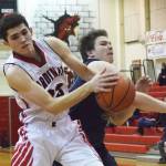 Homers Stanley Swoboda (right) tries to swipe the ball from Kenais Adam Trujillo Thursday, Feb. 14, 2019 in a conference clash at Kenai Central High School in Kenai, Alaska. (Photo by Joey Klecka/Peninsula Clarion)