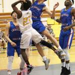 Homers Eyoab Knapp jumps to take a shot under pressure from Anchorage Christian Schools players during a Saturday, Feb. 23, 2019 game in Homer, Alaska. (Photo by Megan Pacer/Homer News)