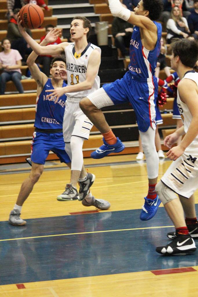 Homers Daniel Reutov jumps to take a shot at the Anchorage Christian Schools basket Saturday, Feb. 23, 2019 during a game at Hoemr High School in Homer, Alaska. (Photo by Megan Pacer/Homer News)