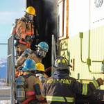Firefighters from multiple agencies prepare to enter a structure with a fire burning inside it as part of a live fire exercise Saturday, Feb. 23, 2019 at the Homer Volunteer Fire Departments fire training facility on Freight Dock Road in Homer, Alaska. Student volunteers rom Anchor Point Emergency Services, Homer Volunteer Fire Department, Ninilchik Emergency Services, and Central Emergency Services attended the drill as part of a joint Firefighter I class they are attending hosted by Anchor Point Fire and HVFD. (Photo by Megan Pacer/Homer News)