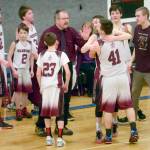 Nikolaevsk coach Steve Klaich celebrates with his team after winning his first Peninsula Conference title in his 30th season at the helm Friday at Cook Inlet Academy in Soldotna. (Photo by Jeff Helminiak/Peninsula Clarion)