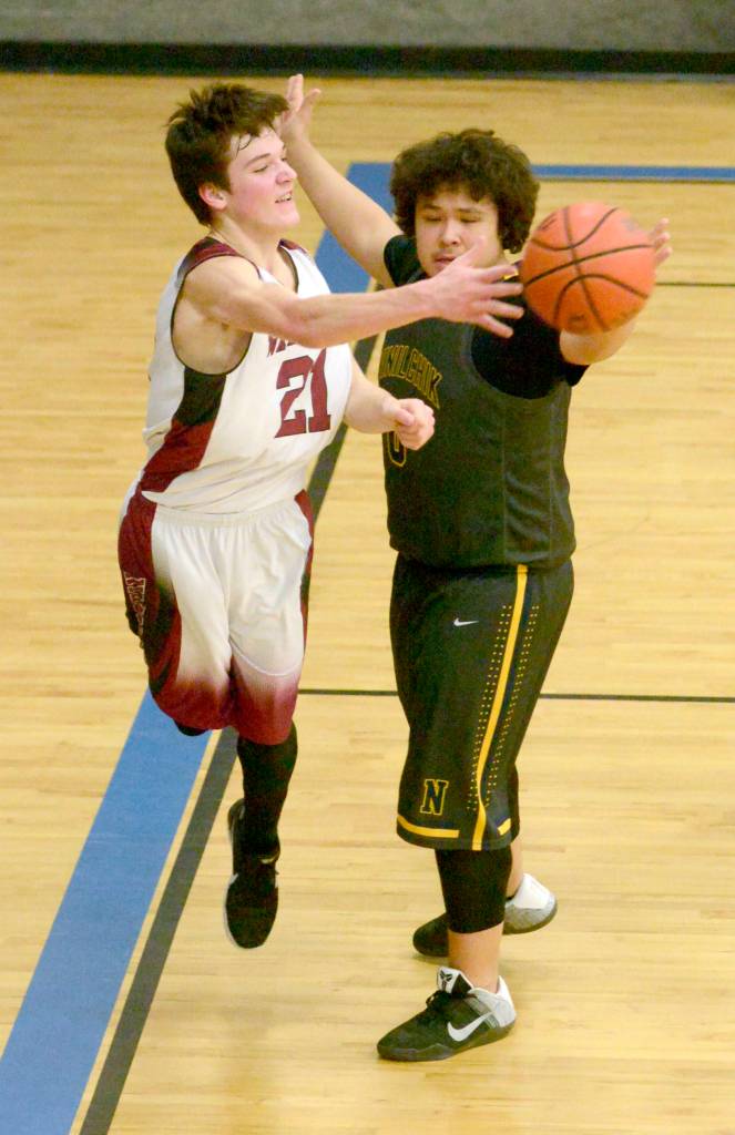 Nikolaevsks Justin Trail saves the ball in front of Ninilchiks George Nelson on Friday during the Peninsula Conference boys championship game at Cook Inlet Academy in Soldotna. (Photo by Jeff Helminiak/Peninsula Clarion)