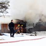 Firefighters douse a blaze that engulfed the old Bay View Inn on the Sterling Highway near the Baycrest Overlook on Thursday, March 7, 2019 in Homer, Alaska. (Photo by Megan Pacer/Homer News)