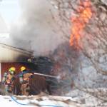 Firefighters douse a blaze that engulfed the old Bay View Inn on the Sterling Highway near the Baycrest Overlook on Thursday, March 7, 2019 in Homer, Alaska. (Photo by Megan Pacer/Homer News)