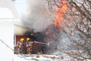 Firefighters douse a blaze that engulfed the old Bay View Inn on the Sterling Highway near the Baycrest Overlook on Thursday, March 7, 2019 in Homer, Alaska. (Photo by Megan Pacer/Homer News)