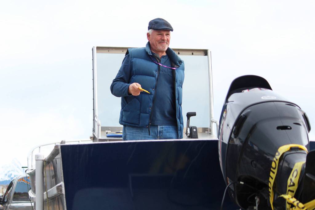 Homer City Council member Tom Stroozas entices people to buy a raffle ticket to win a new boat during the Homer Winter King Salmon Tournament on Saturday, March 23, 2019 on the Homer Spit in Homer, Alaska. (Photo by Megan Pacer/Homer News)
