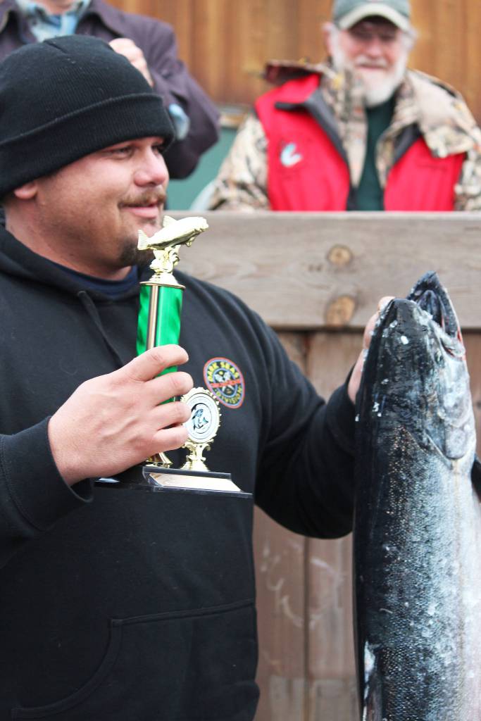William Freeman accepts his third place award for his 24.56-pound king salmon Saturday, March 23, 2019 at the Homer Winter King Salmon Tournament in Homer, Alaska. (Photo by Megan Pacer/Homer News)