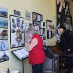Roberta Highland, Sue Christiansen, and Jason Weir examine spill-mobelia included in Still Fighting, an exhibit by Homer artivist Mavis Muller Saturday, March 23, 2019 on display at KBay Caffe in Homer, Alaska. The exhibit recalls the Exxon Valdez oil spill of March 24, 1989, and the response of locals and visitors to protect wildlife and beaches. (Photo by McKibben Jackinsky)