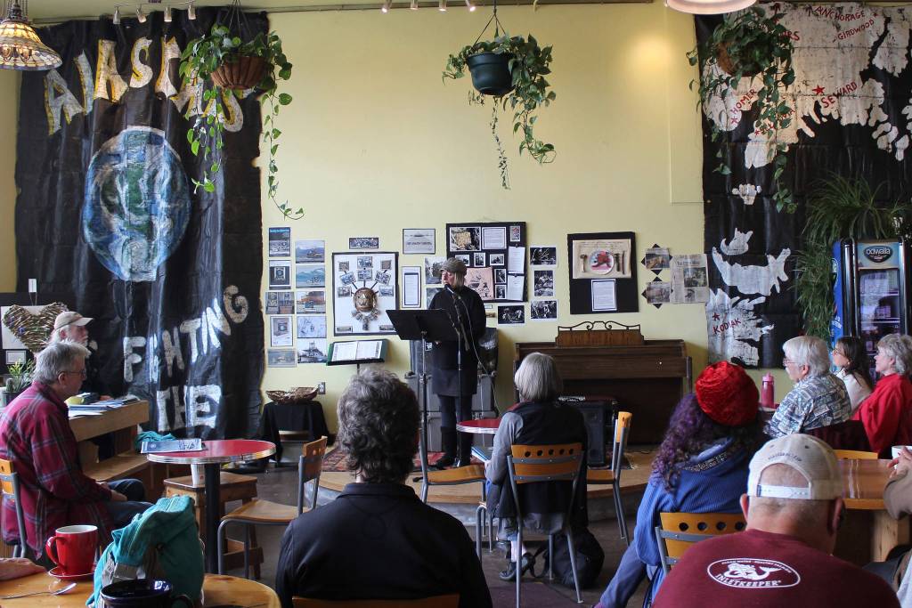 Homer artivist Mavis Muller gives an artist talk at the Saturday, March 23, 2019, opening of Still Fighting, a exhibit at KBay Caffe in Homer, Alaska, commemorating the 30th year anniversary of the Exxon Valdez oil spill. (Photo by McKibben Jackinsky)