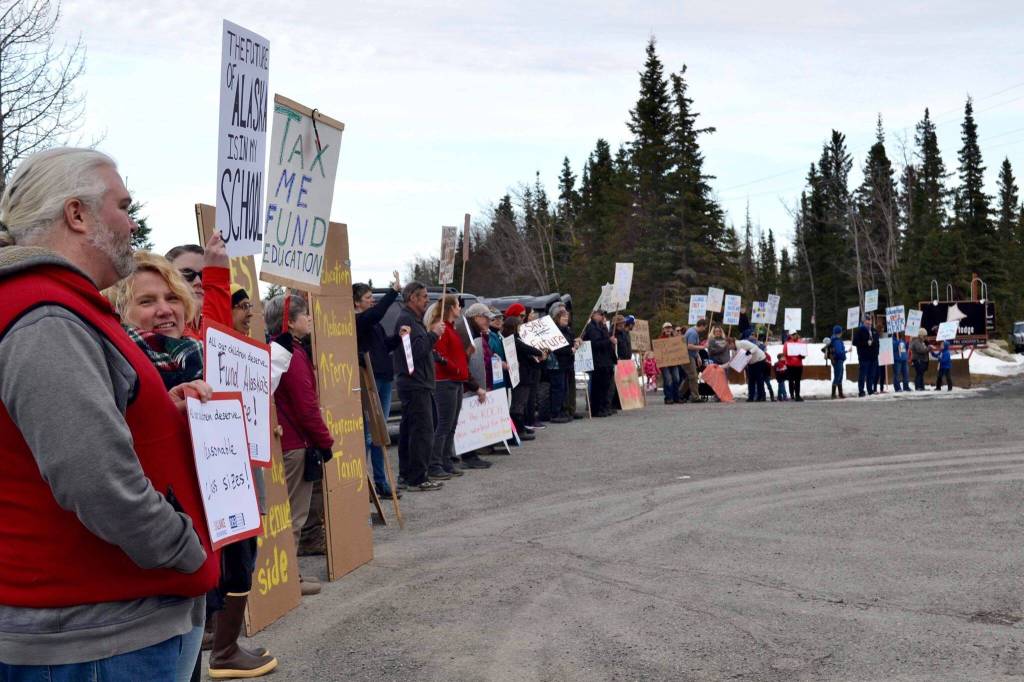 Protesters stand outside the Cannery Lodge in Kenai, Alaska, ahead of Gov. Mike Dunleavys presentation about his proposed budget on March 26, 2019. (Photo by Victoria Petersen/Peninsula Clarion)