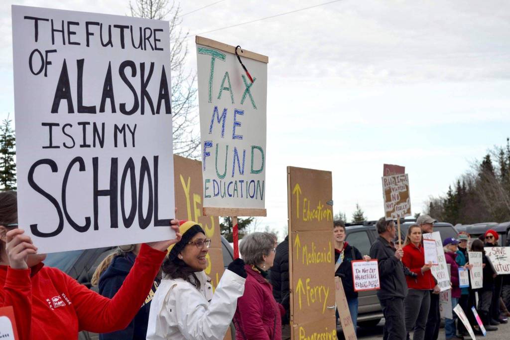 Protesters stand outside the Cannery Lodge in Kenai, Alaska, ahead of Gov. Mike Dunleavys presentation about his proposed budget on March 26, 2019. (Photo by Victoria Petersen/Peninsula Clarion)