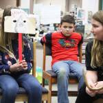 Synnove Neese, left, and Kaiah Stineff, right, act out a restorative justice scenario involving the characters from The Grinch on March 22, 2019 at West Homer Elementary School in Homer, Alaska. Fifth and sixth graders at the school are partaking in a new restorative justice program through the already existing Youth Court program. (Photo by Megan Pacer/Homer News)