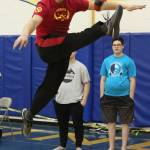 Judah Gason, 16, competes in the one-foot high kick event Saturday, March 30, 2019 during the Kachemak Bay Traditional Games invitational at Homer High School in Homer, Alaska. (Photo by Megan Pacer/Homer News)