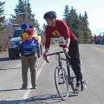 A biker prepares to dismount at a transition point in the Sea to Ski Triathlon held Sunday, March 31, 2019 in Homer, Alaska. (Photo by Megan Pacer/Homer News)