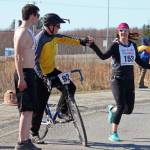 A runner tags her teammate after the first leg of the Sea to Ski Triathlon on Sunday, March 31, 2019 in Homer, Alaska. (Photo by Megan Pacer/Homer News)