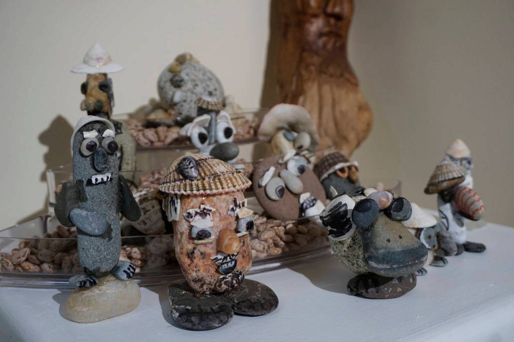 Some of John Fenskes rock people at the First Friday, April 5, 2019, opening for his retrospective showing at Kachemak Bay Campus in Homer, Alaska. (Photo by Michael Armstrong/Homer News)