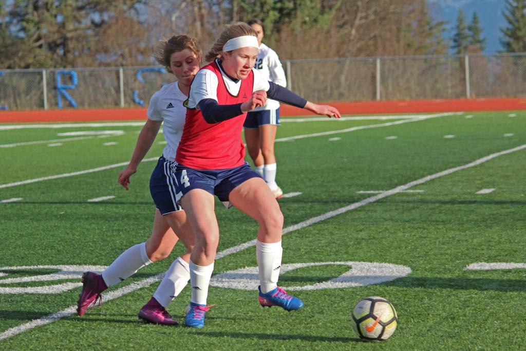 Homers Jessica Sonnen fights to keep the ball from Soldotna High School possession during a Tuesday, April 9, 2019 game in Homer, Alaska. The teams tied 3-3. (Photo by Megan Pacer/Homer News)