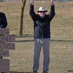 A local demonstrator stands with a sign at WKFL Park on Thursday, April 4, 2019 in Homer, Alaska, joining protests done nationally to prompt the release of special counsel Robert Muellers report of his investigation into Russian interference in the 2016 United States presidential election. (Photo by Megan Pacer/Homer News)