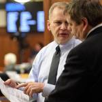 Rep. Mark Neuman, R-Big Lake, left, speaks with Rep. Chris Tuck, D-Anchorage, on the House floor as amendments to the budget are proposed on Tuesday, April 9, 2019. (Michael Penn | Juneau Empire)