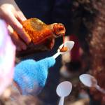 First grade students from Paul Banks Elementary School line up for a taste of Bridge Creek Birch Syrup during a Friday, April 12, 2019 field trip to the grove where the company taps for sap off East End Road in Homer, Alaska. (Photo by Megan Pacer/Homer News)
