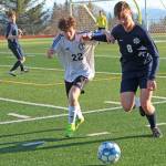 Homers Clayton Beachy fights with Kenais Francisco Garmen Munarriz for possession of the ball during a Tuesday, April 16, 2019 game at Homer High School in Homer, Alaska. (Photo by Megan Pacer/Homer News)