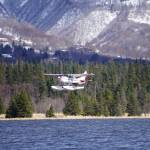 A floatplane takes off from Beluga Lake on Monday afternoon, April 22, 2019, in Homer, Alaska. Although a snow storm brought a taste of winter back to Homer after a deceptive spring, the lake remained open enough for float planes to start using it. (Photo by Michael Armstrong/Homer News)