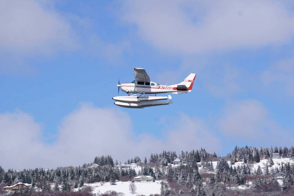 A floatplane takes off from Beluga Lake on Monday afternoon, April 22, 2019, in Homer, Alaska. Although a snow storm brought a taste of winter back to Homer after a deceptive spring, the lake remained open enough for float planes to start using it. (Photo by Michael Armstrong/Homer News)