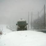 A van moves through blowing snow on Sunday afternoon, April 21, 2019, on Diamond Ridge Road in Homer, Alaska. A spring snowstorm dropped about 6 inches of snow on Homer over the weekend. (Photo by Michael Armstrong/Homer News)